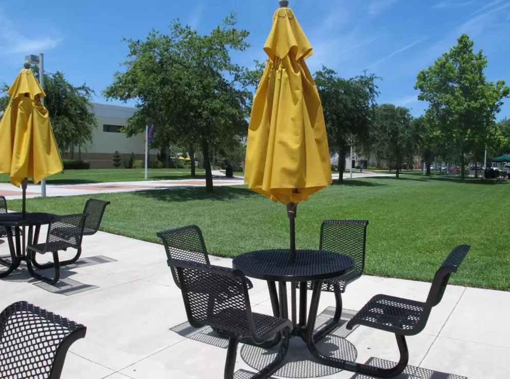 Chairs and tables outside on a gorgeous day on campus.