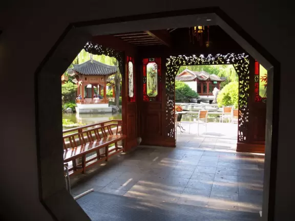 Pleasant garden with waterfall, huge lizards, boulders, pavilions with lovely circle windows and distinctive roofs, and pond, but some city noise.