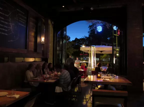 Gorgeous main street with large, European-style park where people sit on the grass by the fountain.