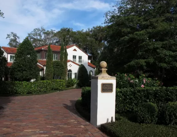 Inspiring walk under tall trees beside a lake and past mansions on hilly roads.