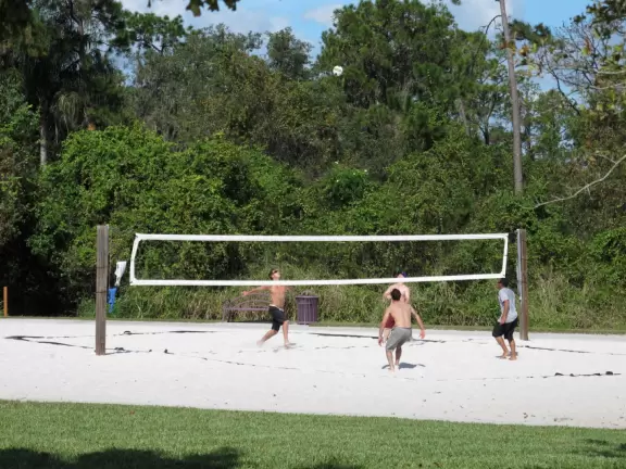 Huge space-age playground for big kids plus toddler playground and splash pad with view of the blue lake.