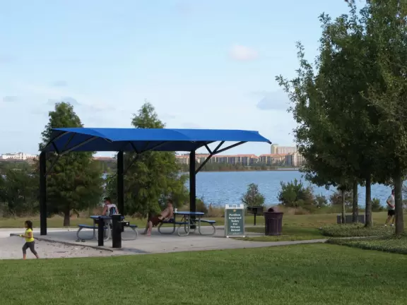 Huge space-age playground for big kids plus toddler playground and splash pad with view of the blue lake.