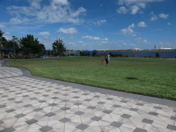 Huge space-age playground for big kids plus toddler playground and splash pad with view of the blue lake.