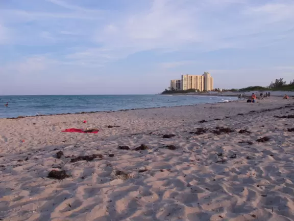 Beach where fishermen hang out on the jetty and surfers come to ride the waves at Jupiter Inlet.