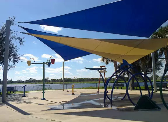 Park on a lake with a ton of playgrounds side by side, and a splash pad!