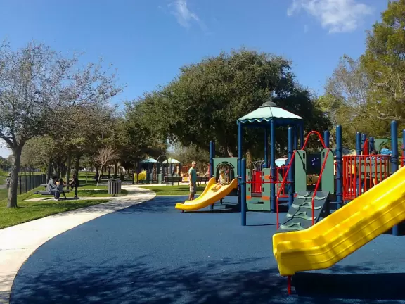 Park on a lake with a ton of playgrounds side by side, and a splash pad!