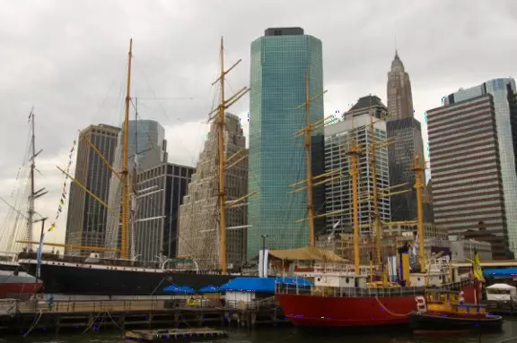 Colorful restored seaport with four gorgeous masted ships, restaurants, bars, and glimpses of the Brooklyn Bridge.