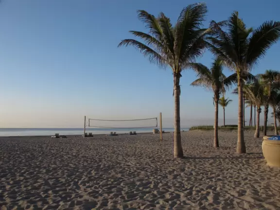 Wide pedestrian and bike path that runs along the beach and past cafes.
