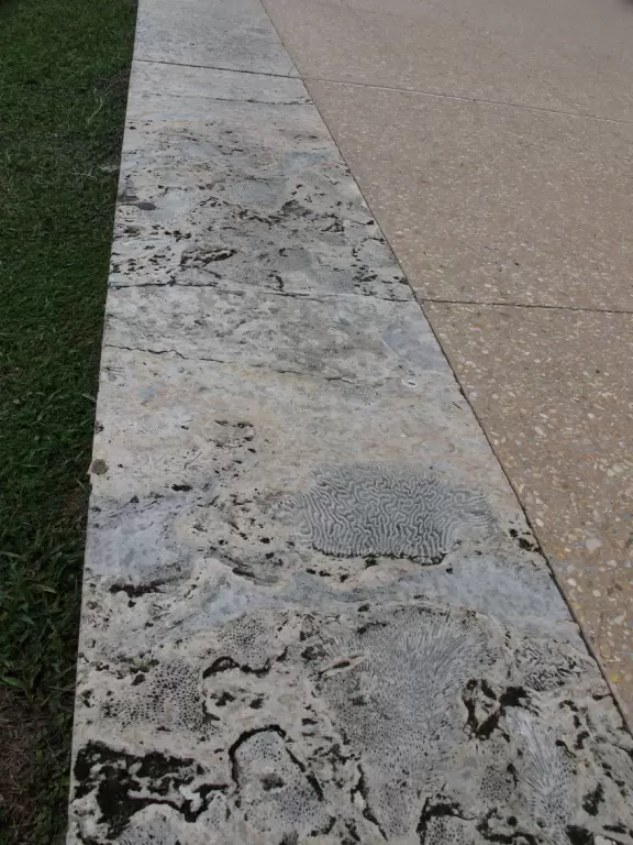 Modern pier, grass hill with winding paths, space-age playground and splash pad, and shady promenade along the water.