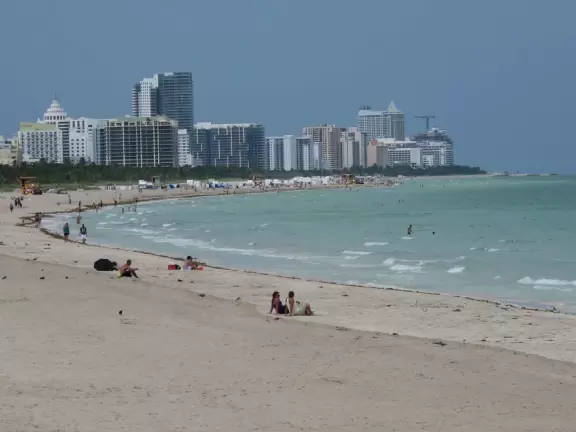 Modern pier, grass hill with winding paths, space-age playground and splash pad, and shady promenade along the water.