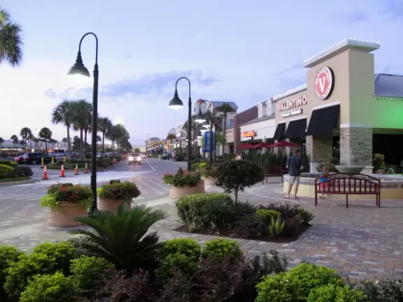 Attractive, modern outdoor mall with music playing, landscaping, and good restaurants.