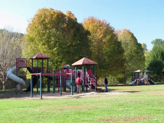 Basic park with big kid and toddler playground, swings, and nice tricycle path.