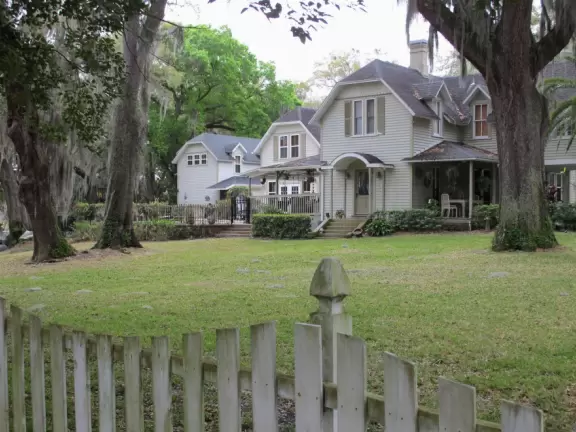 Lovely 1930s homes on lakes, surrounded by lush tropical trees.
