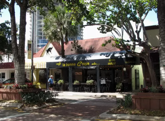 Three-block stretch of restaurants, under a canopy of trees, with sweet 1930s architecture.
