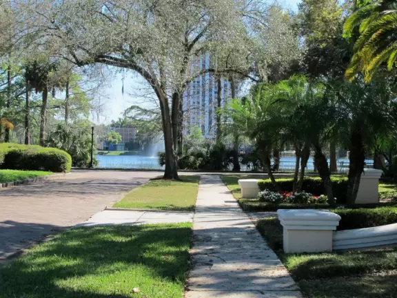 Short walk around shimmering lake with moss-draped trees, past Spanish mansions.