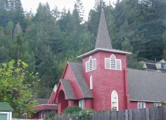 The cutest little town, backed by a forest.