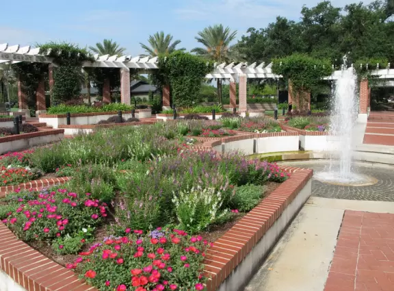 Beautiful park with stone bridges over a bayou and gigantic moss-draped oaks.