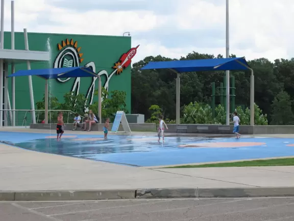 Modern children's museum with cars to race, model train town, ship to climb with basement to explore, and stage with songs to perform.