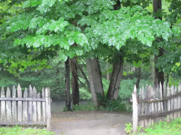 A beautiful river and late 19th century log farm buildings.