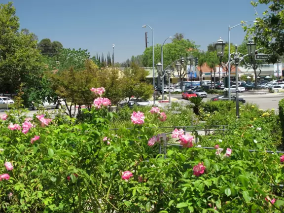 A shopping plaza with sidewalks cafes and shops that would look like Europe if it weren't so new!