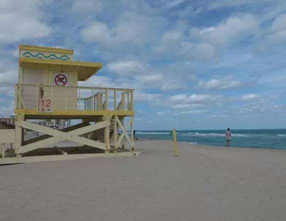Beautiful beach with golden sand and turquoise water, plus a clothing-optional area.