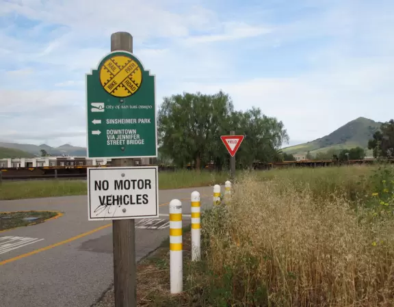 Bike path with views of hills all around, and pretty neighborhood nearby.