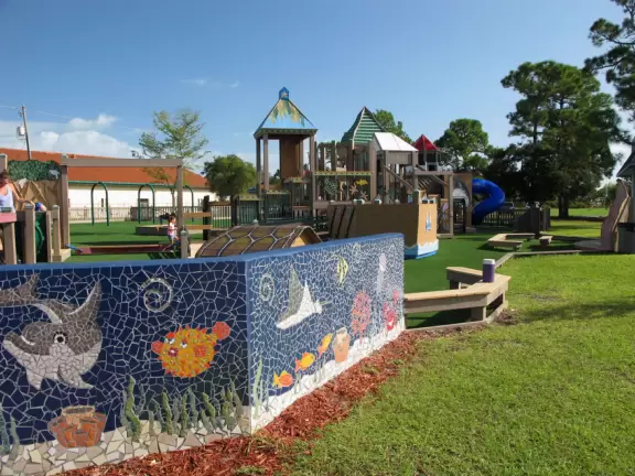 Imaginative beach-themed pseudo-wood playground, with tons of cool play equipment!