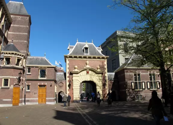 Giant sunny cobblestone square with cafes.
