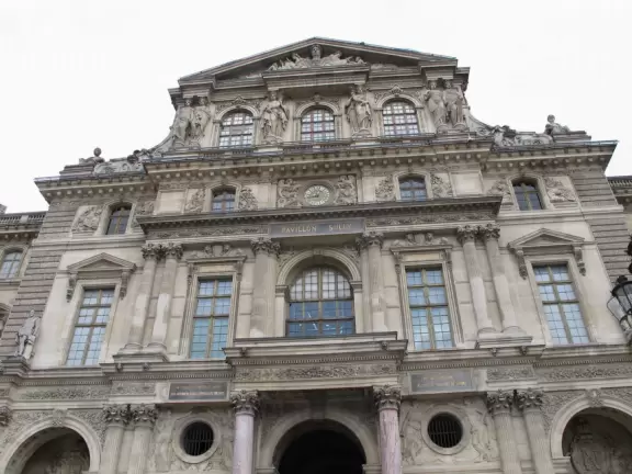 A glass and metal pyramid in the entry courtyard of the Louvre Museum, truly glorious at night!