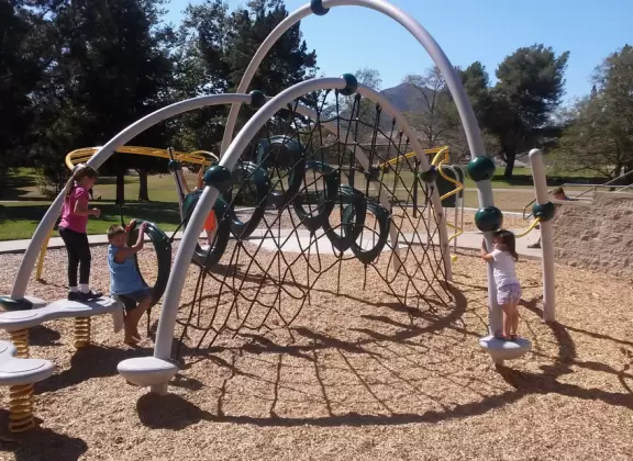 A lush park with rolling hills to run on, one-mile loop walking path, and basketball and sand volleyball courts. Currently has a crime problem.