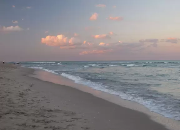 Beach with cute pier and aquamarine water.