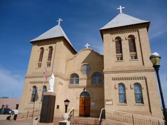 Adorable square with basilica, bandstand, cute shops, cafes with adobe walls and flowers.