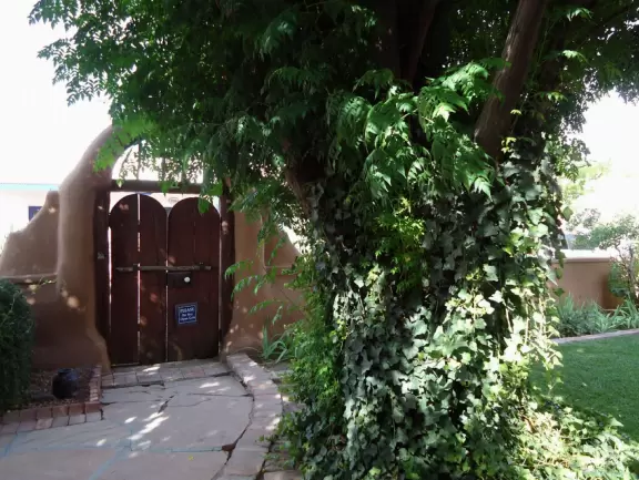 Adorable square with basilica, bandstand, cute shops, cafes with adobe walls and flowers.