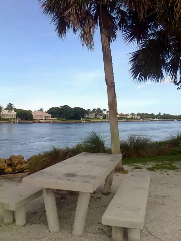 Large lagoon with clear water where kids can swim, tons of shade, and playground in the sand.