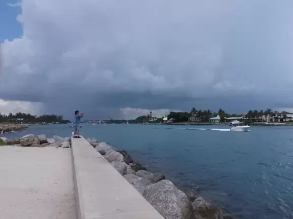 Beach where fishermen hang out on the jetty and surfers come to ride the waves at Jupiter Inlet.