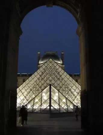 A glass and metal pyramid in the entry courtyard of the Louvre Museum, truly glorious at night!
