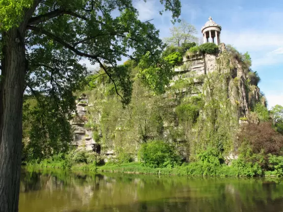 Beautiful, hilly park with jade green lake and fake caves and rock formations.
