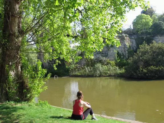 Beautiful, hilly park with jade green lake and fake caves and rock formations.