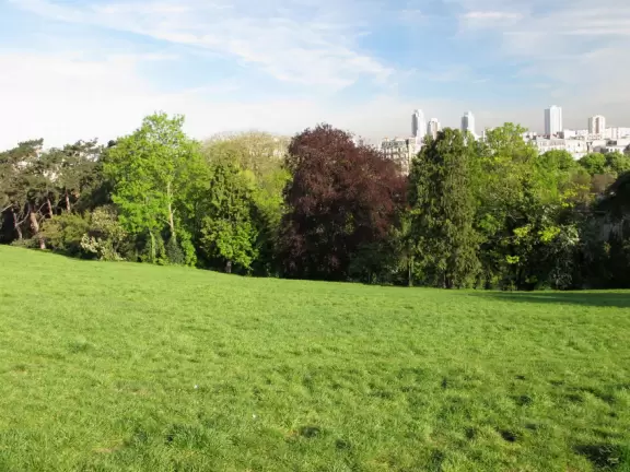 Beautiful, hilly park with jade green lake and fake caves and rock formations.