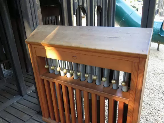 Giant wooden castle playground set among tropical palms.