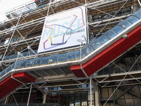 Modern art museum and public library with sunny, slanted square in front, and awesome modern art fountain.