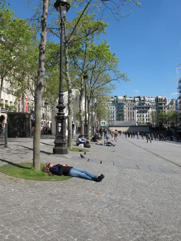 Modern art museum and public library with sunny, slanted square in front, and awesome modern art fountain.