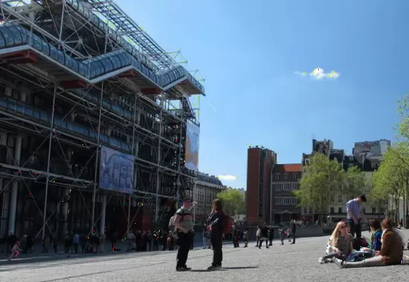 Modern art museum and public library with sunny, slanted square in front, and awesome modern art fountain.