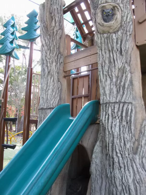 Lovely forest-themed playground, along the bike path, with water and pier across the street.