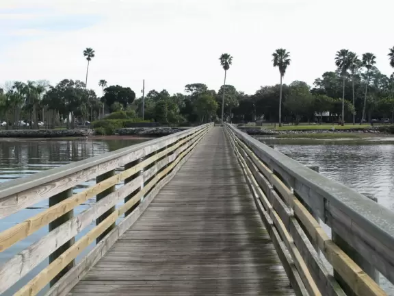 Lovely forest-themed playground, along the bike path, with water and pier across the street.