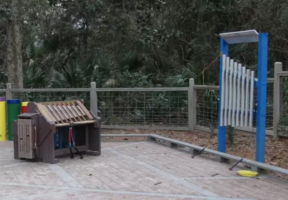 Playground in a forest setting with water/mud play.