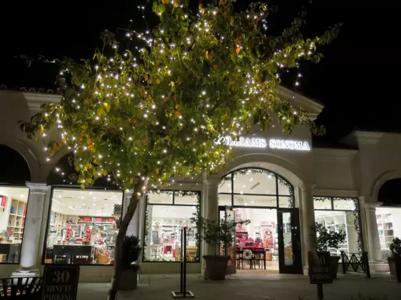 A shopping plaza with sidewalks cafes and shops that would look like Europe if it weren't so new!