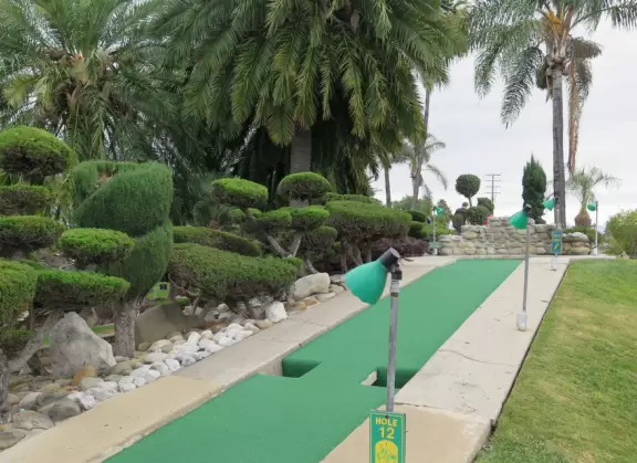 Mini-golf park with lush, colorful grounds, plus arcade games, mini-carousel, and rides.