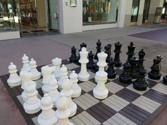 A pretty mall filled with flower pots and giant sized games, with views of the mountains and plenty of stores for kids!