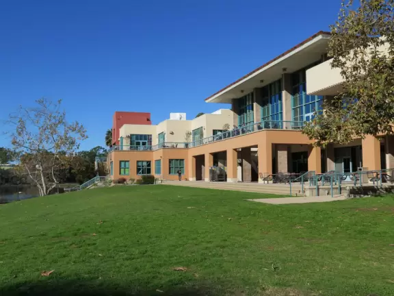 A walk past grassy knolls, a shimmering lagoon, and picturesque bluffs above the ocean, all in the vibrant atmosphere of campus!